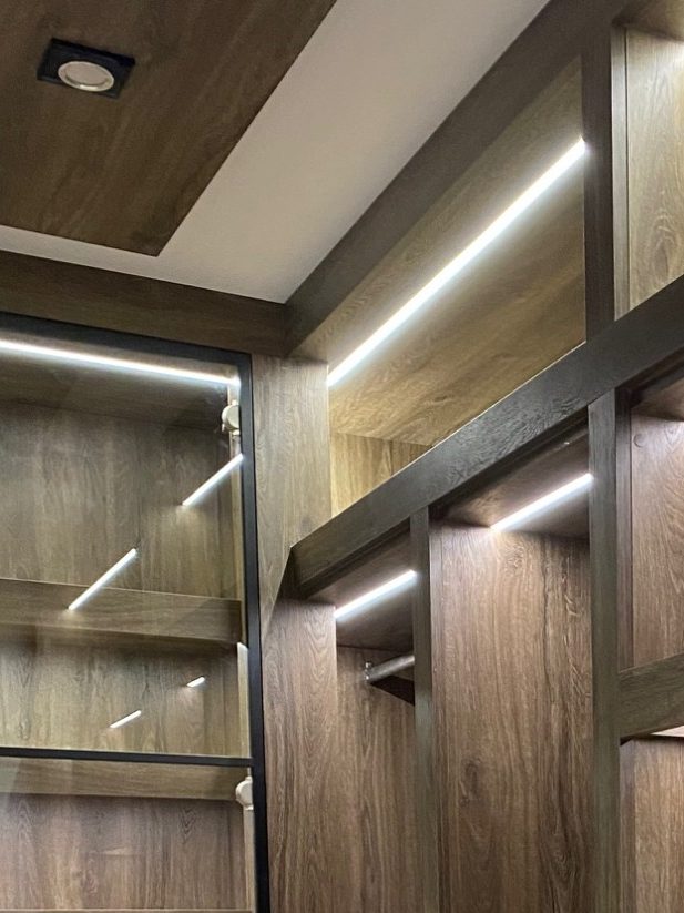 Modern interior with wooden panels and ambient lighting accents.