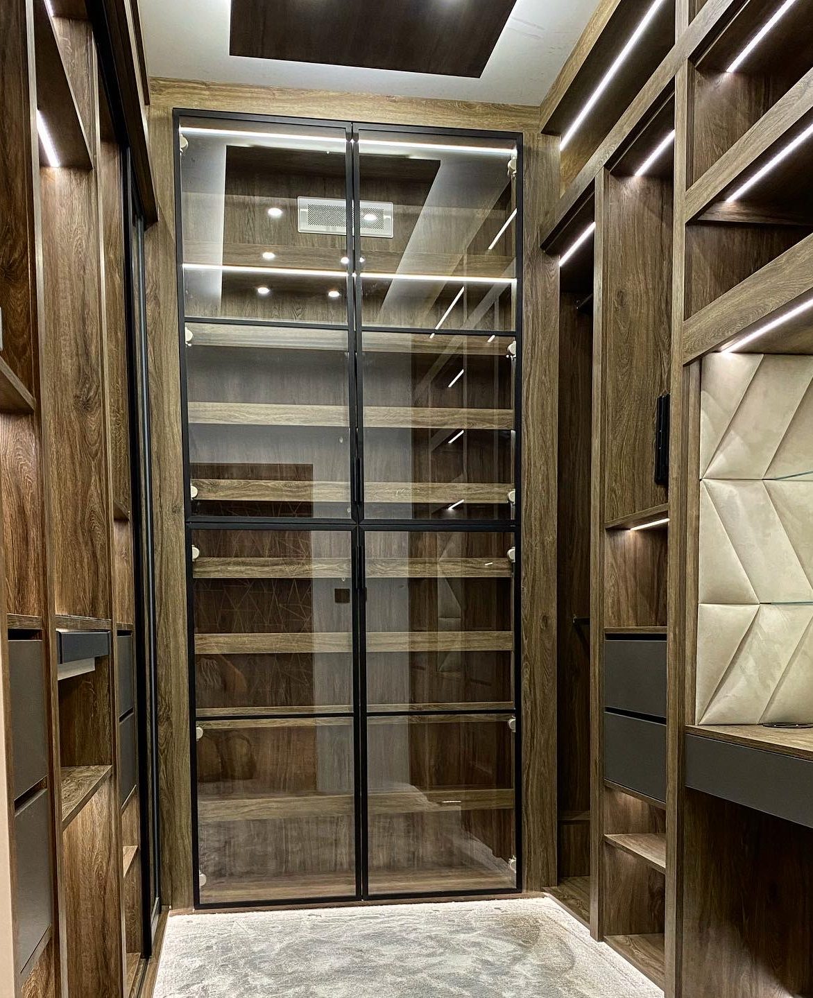 High-end bespoke wardrobe with integrated LED lighting, premium wood interiors and custom glass doors by Crafidea Bespoke