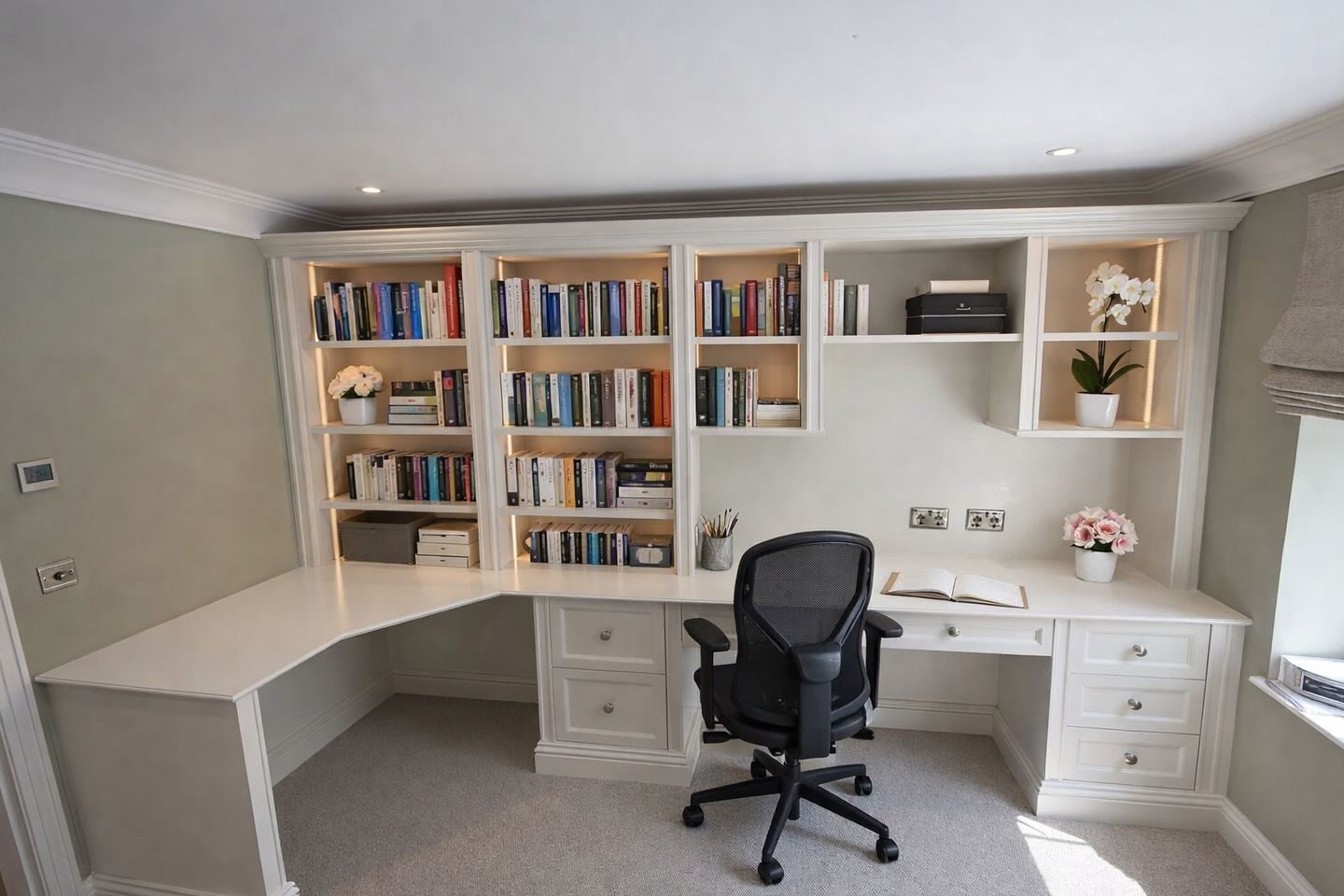 A bespoke entertainment unit designed and built in the UK, featuring integrated storage, shelving and a seamless media wall finish