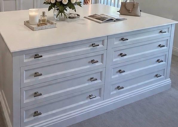 Stylish white dresser with six drawers, set in a bright, modern room.